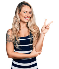 Sticker - Young blonde woman wearing casual clothes smiling with happy face winking at the camera doing victory sign. number two.