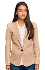 Canvas Print - Beautiful hispanic woman wearing business jacket relaxed with serious expression on face. simple and natural looking at the camera.