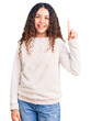 © Krakenimages.com - Beautiful kid girl with curly hair wearing casual clothes showing and pointing up with finger number one while smiling confident and happy.