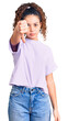 © Krakenimages.com - Beautiful kid girl with curly hair wearing casual clothes looking unhappy and angry showing rejection and negative with thumbs down gesture. bad expression.