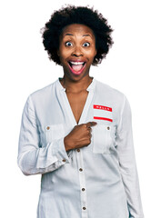 Poster - African american woman with afro hair wearing hello my name is sticker identification celebrating crazy and amazed for success with open eyes screaming excited.