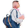 © Krakenimages.com - Hispanic woman with pink hair wearing student backpack and headphones looking to side, relax profile pose with natural face and confident smile.