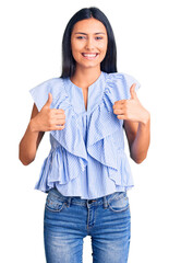 Sticker - Young beautiful latin girl wearing casual clothes success sign doing positive gesture with hand, thumbs up smiling and happy. cheerful expression and winner gesture.