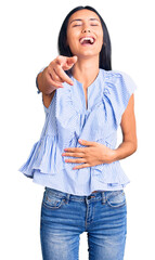 Canvas Print - Young beautiful latin girl wearing casual clothes laughing at you, pointing finger to the camera with hand over body, shame expression