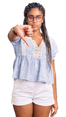 Canvas Print - Young african american woman with braids wearing casual summer clothes and glasses looking unhappy and angry showing rejection and negative with thumbs down gesture. bad expression.