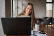 © Andromeda - Young women working with laptop while sitting at café