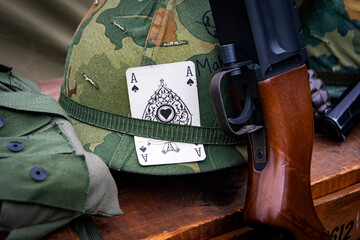 Military camouflage assault helmet with card and rifle