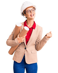 Sticker - Young beautiful woman wearing architect hardhat and glasses holding blueprints screaming proud, celebrating victory and success very excited with raised arms