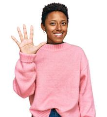 Wall Mural - Young african american woman wearing casual clothes showing and pointing up with fingers number five while smiling confident and happy.