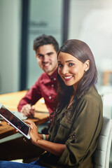 Fototapete - Finding new ways to connect to opportunities out there. Portrait of two young designers working together on a digital tablet in an office.
