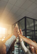 © Donson/peopleimages.com - Touch times dont last but touch teams do. Shot of a group of colleagues giving each other a high five.