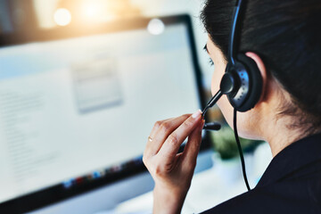 Poster - Managing the days inquiries. Rearview shot of a young woman working in a call centre.
