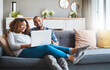 © Donson/peopleimages.com - The comfort of couch surfing. Shot of a young couple relaxing on the sofa at home and using a laptop together.