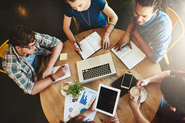 Poster - Technology is a fantastic resource for study tools. High angle shot of a group of students studying in a coffee shop.