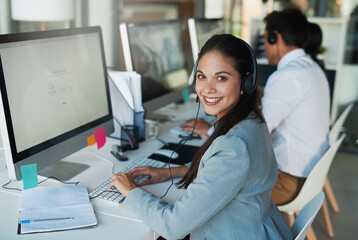 Wall Mural - Her clients appreciate her friendly demeanor. Portrait of a happy and confident young woman working in a call center.