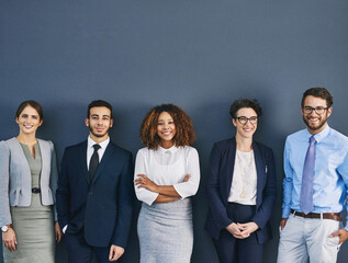 Aufkleber - Weve each got our role to play. Studio shot of a group of businesspeople standing in line against a gray background.
