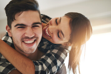 Poster - Love is all we need to be happy. Portrait of a happy young couple celebrating their move into a new home.