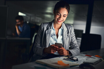Leinwandbilder - Success will come to those who work for it. Shot of a young attractive businesswoman working late at night in a modern office.