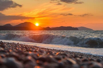 Wall Mural - Sea coast with stones at sunrise. Beach of Black sea