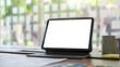 © wattana - Digital tablet with blank display, document and coffee cup on white office desk.