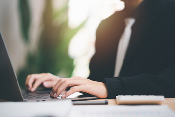 Fototapete - Businessman calculating figures in company financial documents with a calculator ,analysis of company financial data ,Planning to assess and review budgets ,concept of finance and investment.