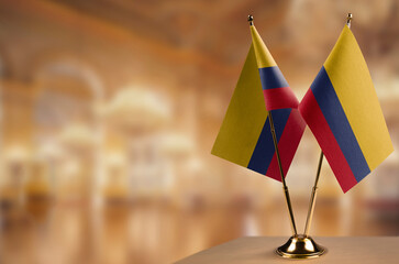 Wall Mural - Small flags of the Colombia on an abstract blurry background