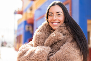 Poster - Young brunette woman at outdoors With glasses with happy expression