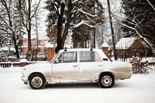 An Empty Old White Car Sits On The Side Of A Snow Covered Road In The Winter In The Carpathian Mountains In Ukraine.