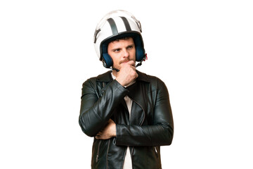 Wall Mural - Brazilian man with a motorcycle helmet over isolated chroma key background having doubts and thinking