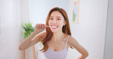 Wall Mural - asian smiling woman brush teeth