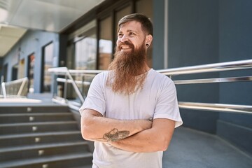 Sticker - Young redhead man smiling confident standing with arms crossed gesture at street