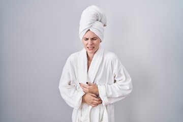 Sticker - Blonde caucasian woman wearing bathrobe with hand on stomach because indigestion, painful illness feeling unwell. ache concept.