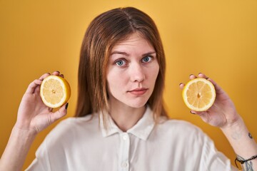 Sticker - Beautiful woman holding lemons skeptic and nervous, frowning upset because of problem. negative person.