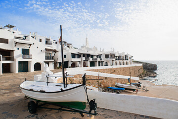 Wall Mural - Binibeca town, Menorca island, Spain, Beautiful view of old town with boat