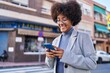 © Krakenimages.com - African american woman executive smiling confident using smartphone at street
