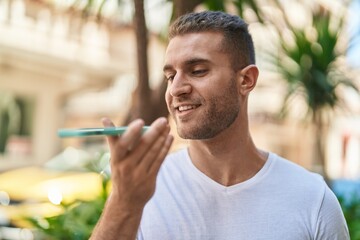 Canvas Print - Young caucasian man smiling confident talking on the smartphone at street