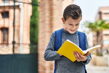 Poster - Blond child student reading book standing at street