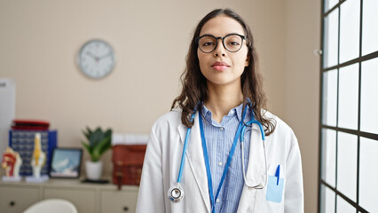 Sticker - Young beautiful hispanic woman doctor standing with serious expression at clinic