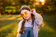 © cenchild - school girl walk and rest on lawn with green trees background
