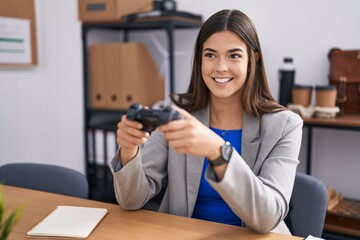 Poster - Hispanic woman working at the office playing video games smiling with a happy and cool smile on face. showing teeth.