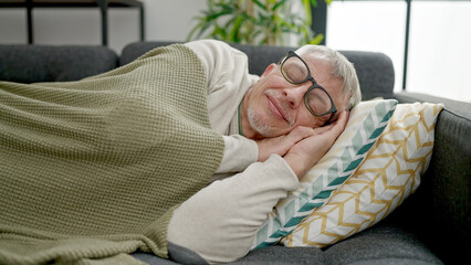 Poster - Middle age grey-haired man lying on sofa sleeping at home