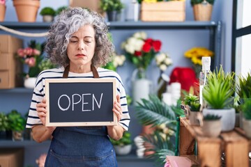 Wall Mural - Middle age woman with grey hair working at florist with open sign depressed and worry for distress, crying angry and afraid. sad expression.