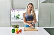 © Krakenimages.com - Young woman smiling confident scratching carrot for salad at kitchen