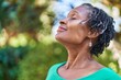 © Krakenimages.com - Middle age african american woman smiling confident breathing at park