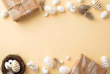 Wall Mural - Easter concept. Top view photo of white and gold easter eggs craft paper gift boxes ceramic bunny quail nest and feathers on isolated beige background with copyspace