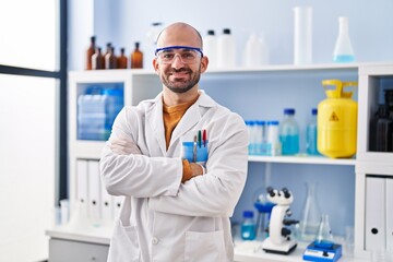 Poster - Young man scientist standing with arms crossed gesture at laboratory