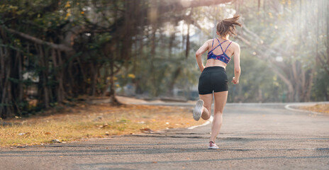 Young woman runner running in the park.
