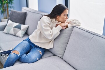 Wall Mural - Young hispanic woman stressed sitting on sofa at home