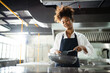 © DG PhotoStock - Happy African - black professional chef cooking in kitchen in restaurant.