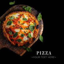 Top View Of Classic Italian Uncut Margherita Pizza With Tomatoes, Mozzarella Cheese And Fresh Basil Leaves Served On Baking Shovel. Cheesy Pizza Isolated On Black Background With Text And Copy Space